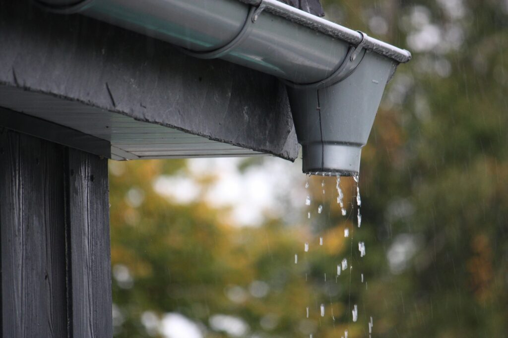 Gutters Overflowing During Heavy Rainfall In Autumn